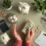 U.S. homeowner setting aside cash in envelopes for car repairs and annual insurance.