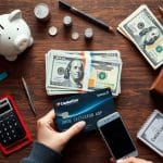 U.S. cardholder reviewing a Capital One statement and settlement options at a kitchen table